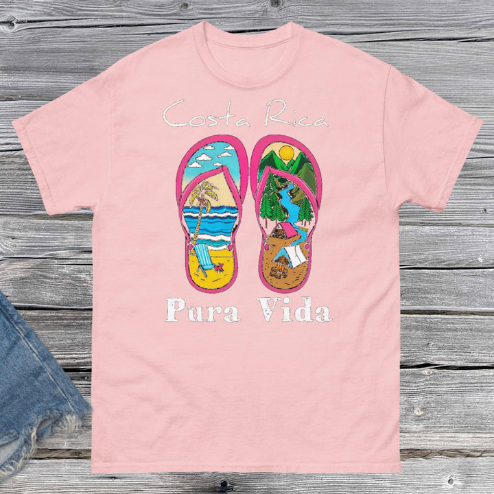 ProductProduct m"Unisex classic fit t-shirt featuring a vibrant collage-style design that celebrates Costa Rica, including tropical elements like toucans, sloths, beaches, waves, and jungle foliage. The colorful graphic is set against a neutral shirt color, capturing the laid-back and adventurous spirit of Pura Vida." mockup