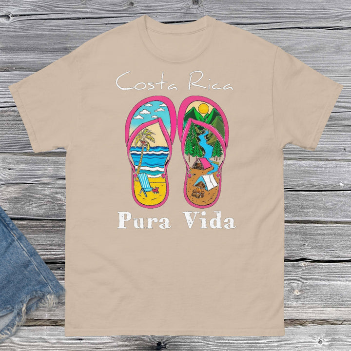Product Product m"Unisex classic fit t-shirt featuring a vibrant collage-style design that celebrates Costa Rica, including tropical elements like toucans, sloths, beaches, waves, and jungle foliage. The colorful graphic is set against a neutral shirt color, capturing the laid-back and adventurous spirit of Pura Vida."mockup
