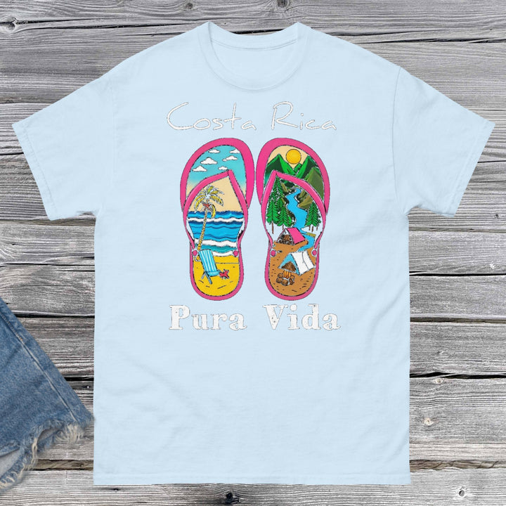 ProduProduct m"Unisex classic fit t-shirt featuring a vibrant collage-style design that celebrates Costa Rica, including tropical elements like toucans, sloths, beaches, waves, and jungle foliage. The colorful graphic is set against a neutral shirt color, capturing the laid-back and adventurous spirit of Pura Vida."ct mockup